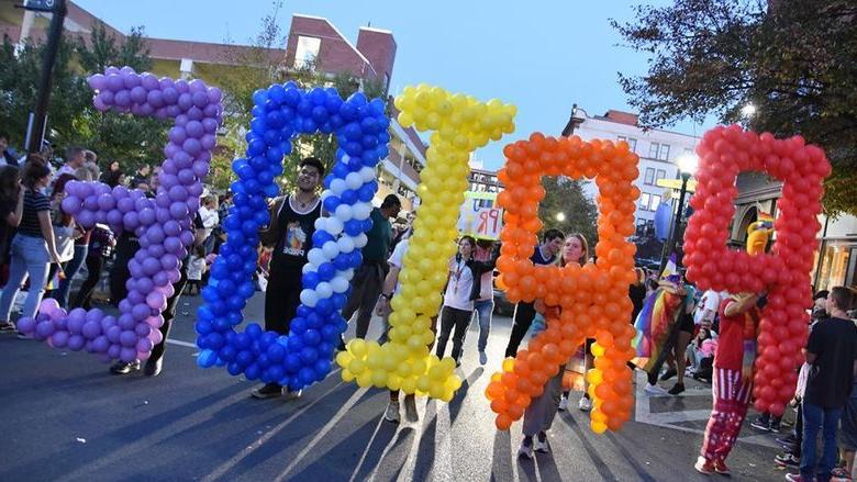 Five students hold balloons spelling PRIDE in the 2019 Altoona Pride Parade